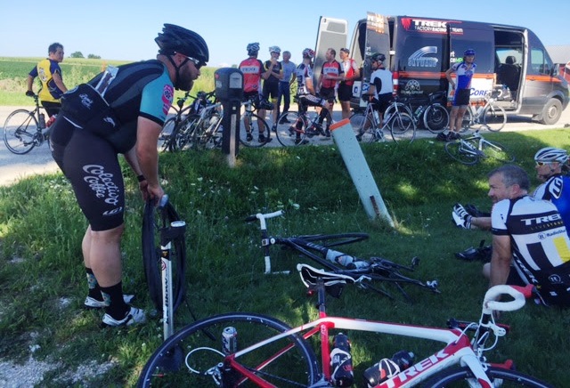 Helping someone change a flat is best done by sitting down and making fun of them.